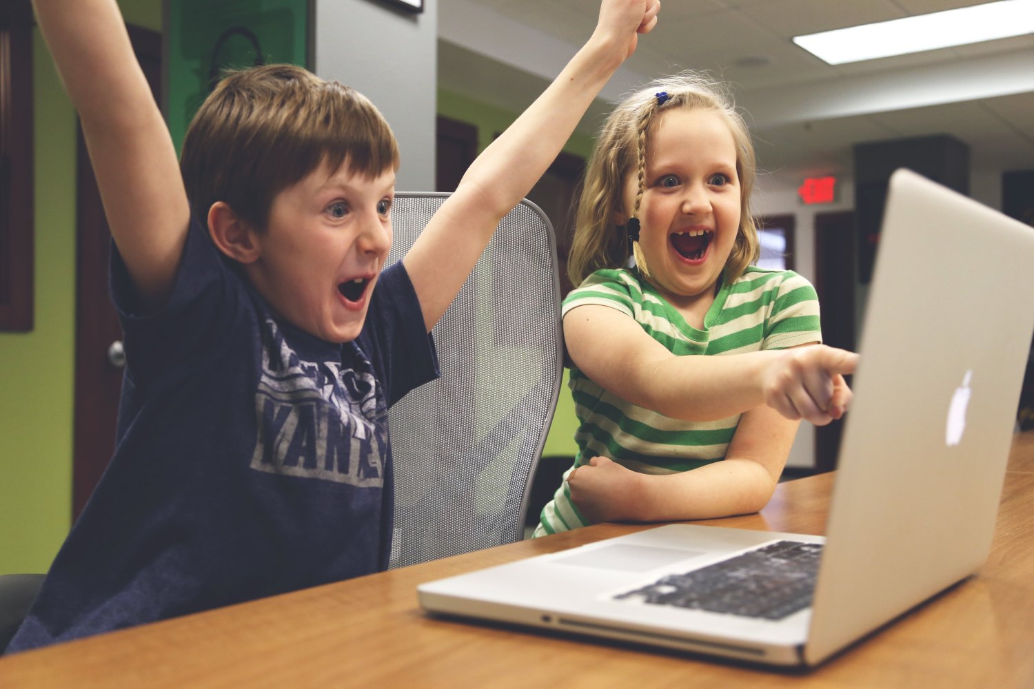 Excited children with computer